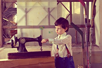 Boy with vintage sewing machine
