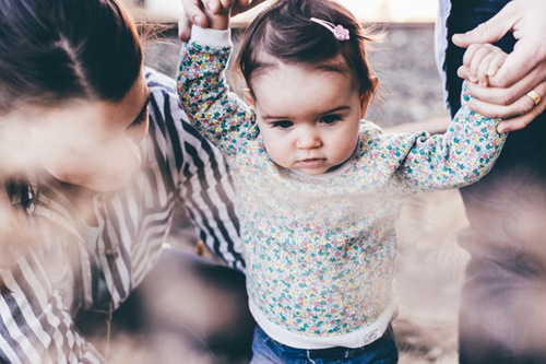 Child holding hands walking