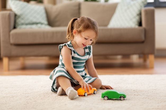 Kid playing best sale with toy cars