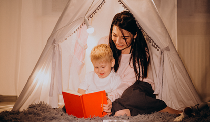 Mother reading a story in a play tent