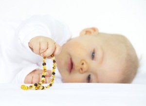Baby with amber teething necklaces