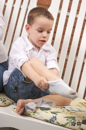 boy getting dressed for school